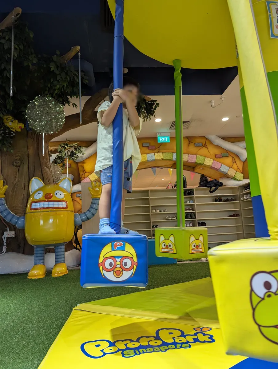 A child climbing on the Pororo-themed play structures at Pororo Park, Marina Square.