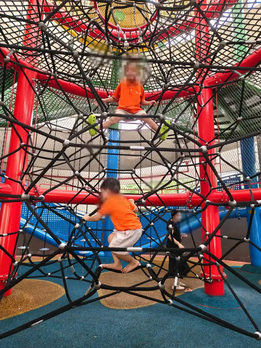 A child on the rope-climb net at Coastal PlayGrove, East Coast Park.