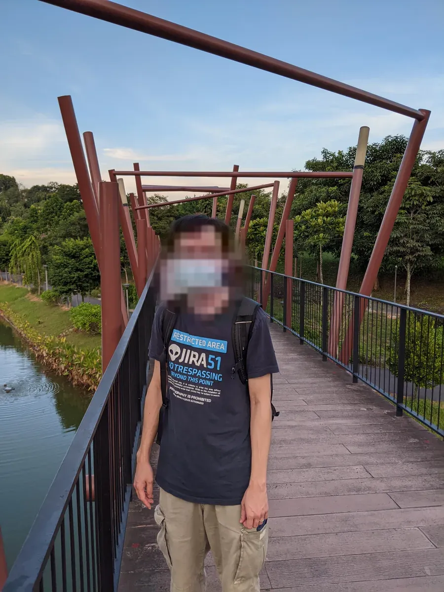On the red pedestrian bridge over the water at Punggol Waterway Park.