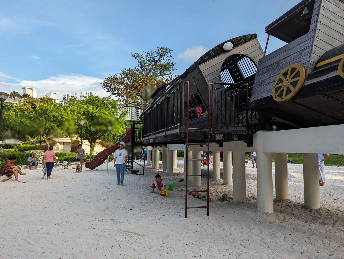 The black locomotive play structure on sand at Tiong Bahru Park.